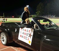 Homecoming Court Candidates in Car at Football Game