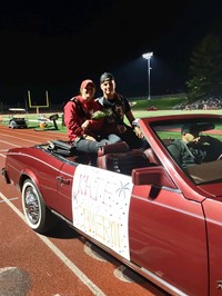 Homecoming Court Candidates in Car at Football Game