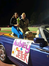 Homecoming Court Candidates in Car at Football Game