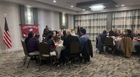 wide shot of Chenango Valley Alumni Association president speaking on behalf of dr. heysek