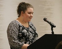 Student introducing Peg Peters at Alumni Recognition Event