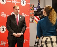 Jared Kraham being interviewed by reporter