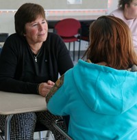 Peg Peters speaking with student