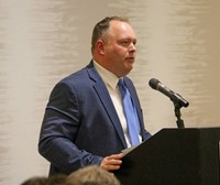 Matt Sheehan speaking at alumni recognition event