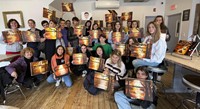 French Exchange students holding paintings