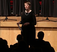 chorus teacher speaking to audience