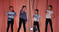 four students participating in talent show