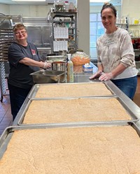 food services employees making pizzas