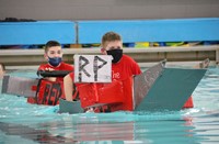 students participating in cardboard boat races