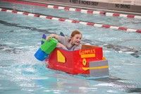student participating in cardboard boat races