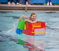 student participating in cardboard boat races