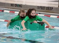 students participating in cardboard boat races