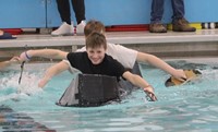 students participating in cardboard boat races