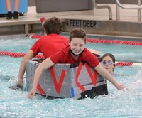 students participating in cardboard boat races