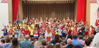 first grade students singing at sing along event