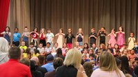 first grade students singing at sing along event