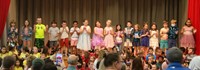 first grade students singing at sing along event