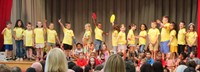 first grade students singing at sing along event