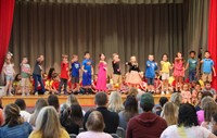 first grade students singing at sing along event