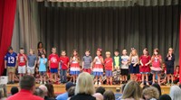 first grade students singing at sing along event