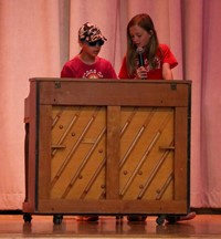 student singing and student playing piano at talent show