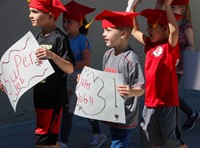 students walking holding signs