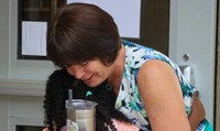 student hugging staff member on first day of school