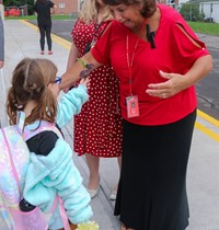 student giving principal flower on first day of school