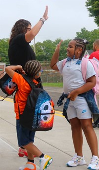 mrs. whittaker giving student high five on first day of school