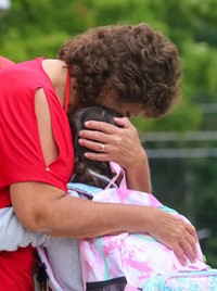 student hugging principal on first day of school