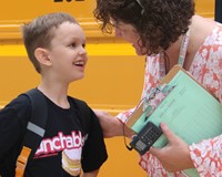 student talking to teacher on first day of school