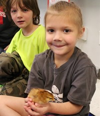 student holding chick
