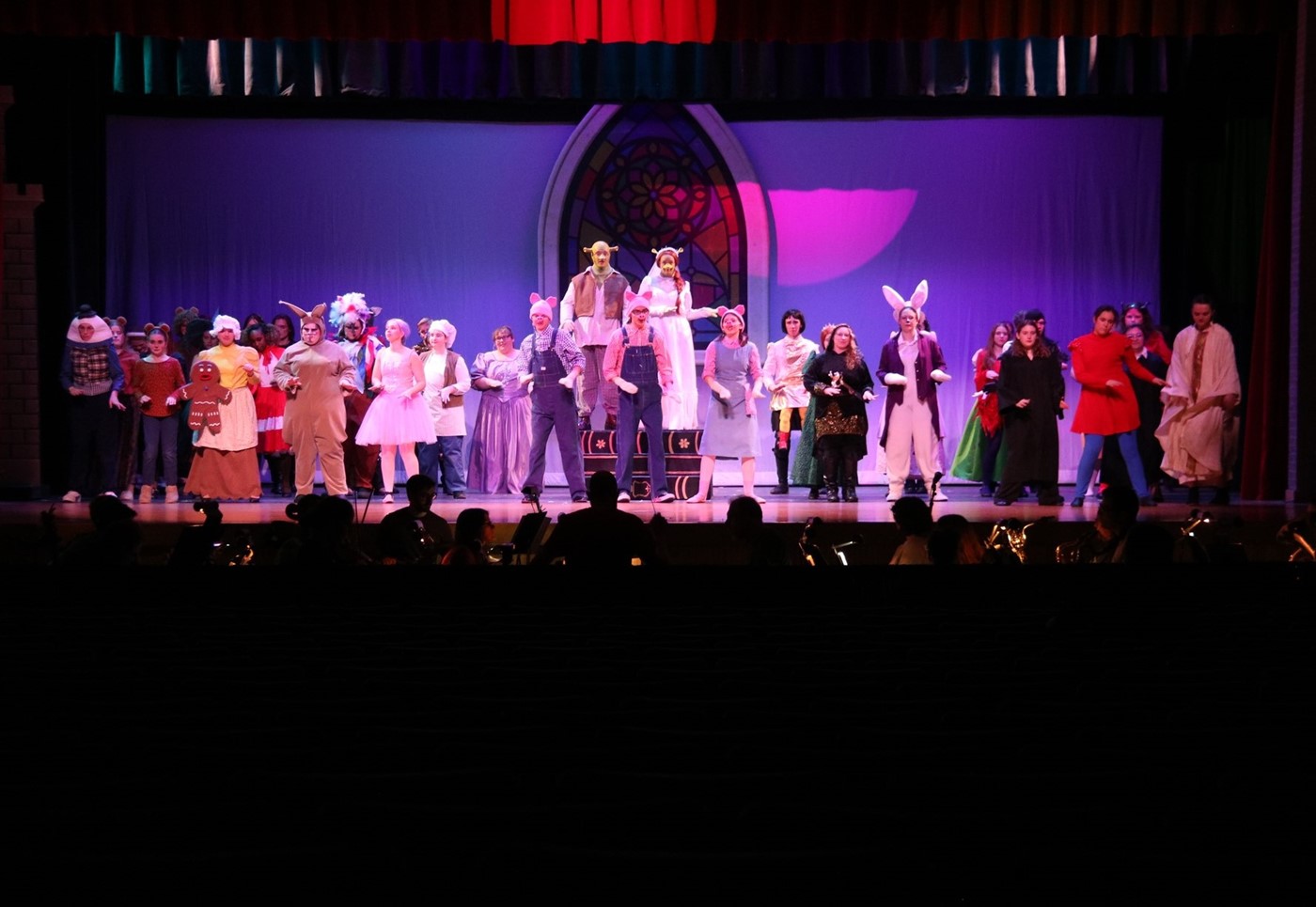 cast members performing on stage