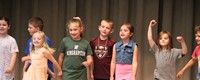 students participating in first grade show