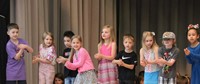 students participating in first grade show